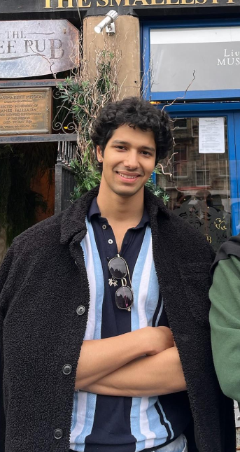 Purunjai standing in front of a pub in Edinburgh